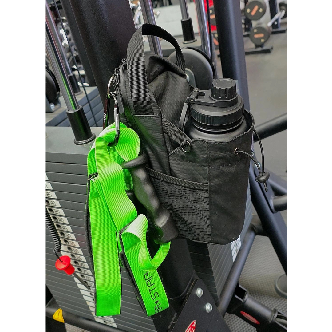 BOSì magnetic gym bag attached securely to metal gym rack during workout.